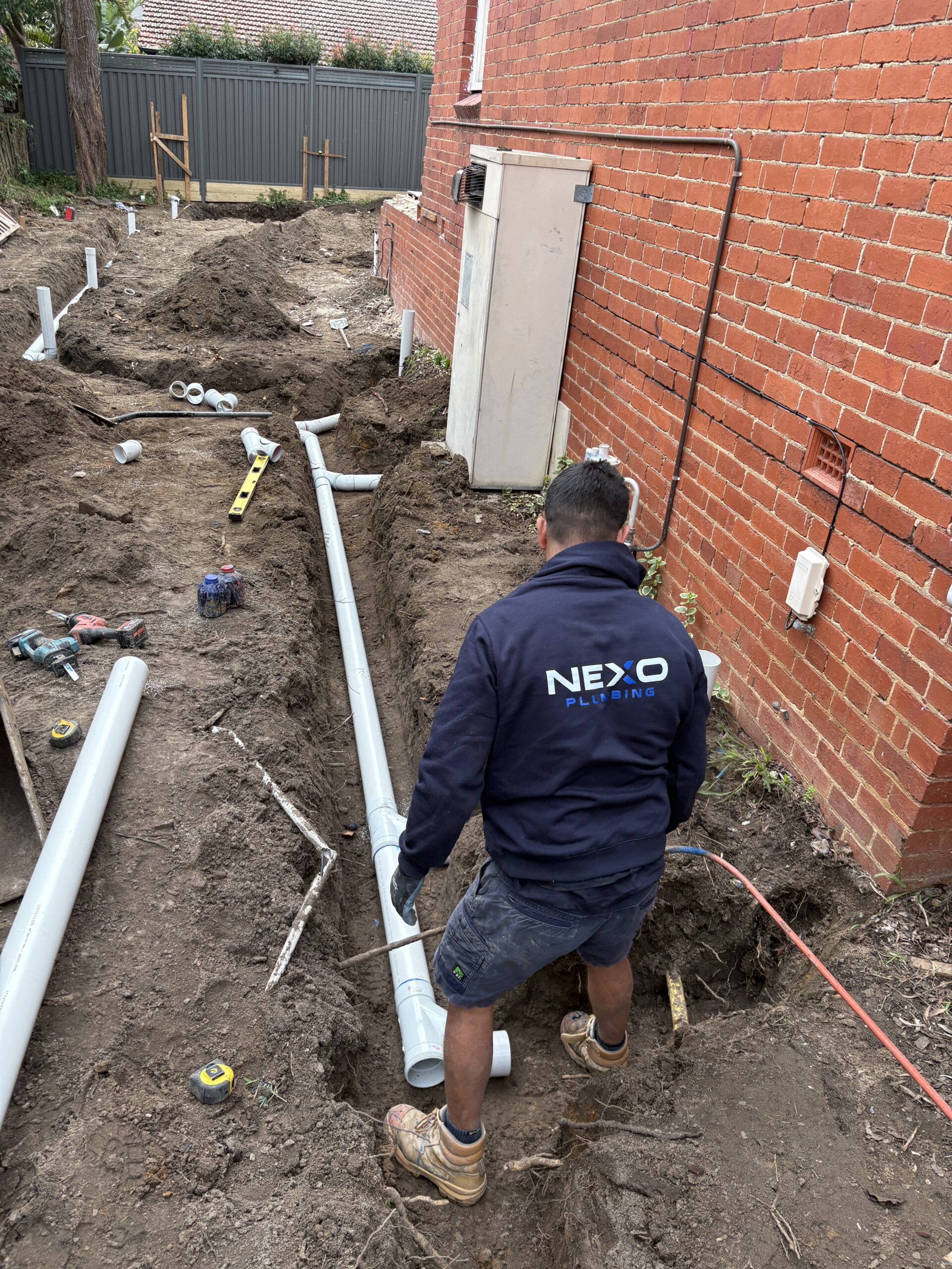 Licensed plumber working on residential sink plumbing in Melbourne