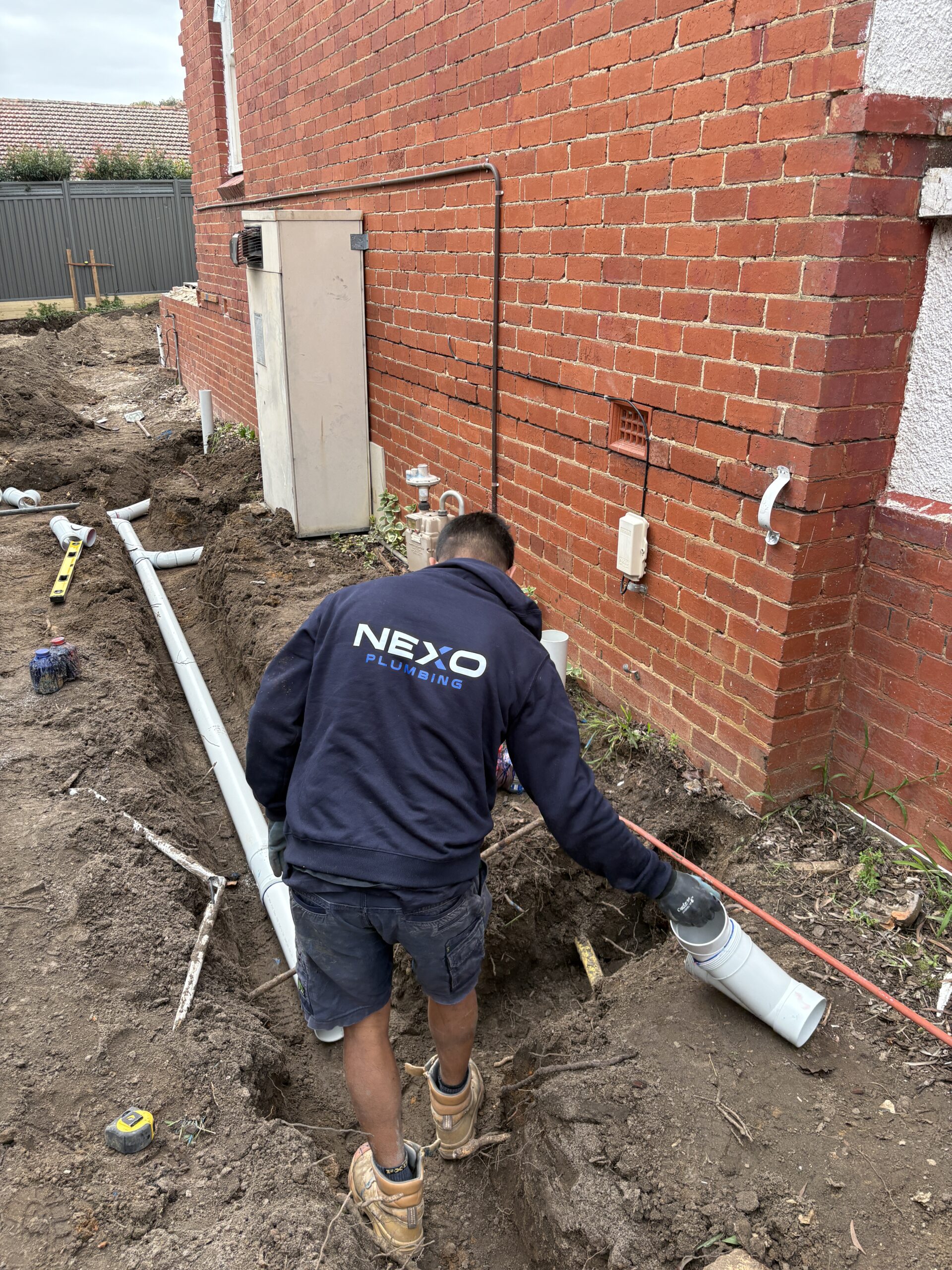 Nexo Plumbing team member working on residential plumbing